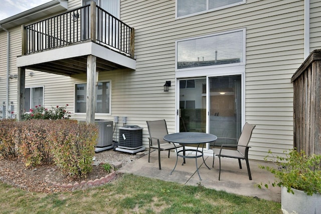 view of patio featuring central AC and a balcony