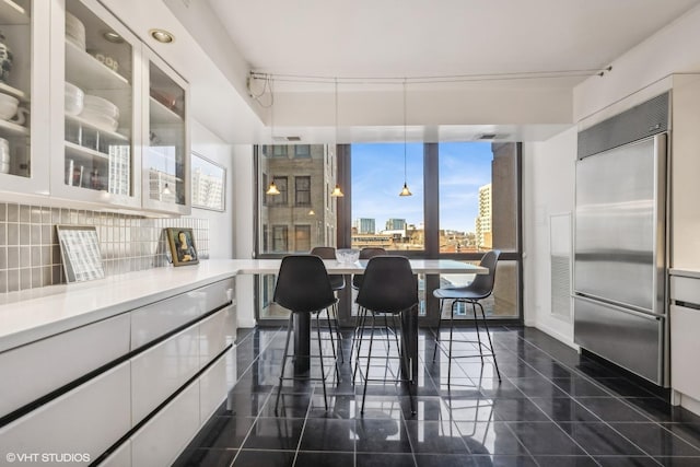 2314 N Lincoln Park W Unit 8-9S, Chicago, IL 60614 - dining space featuring dark tile patterned floors, a wall of windows, and a city view