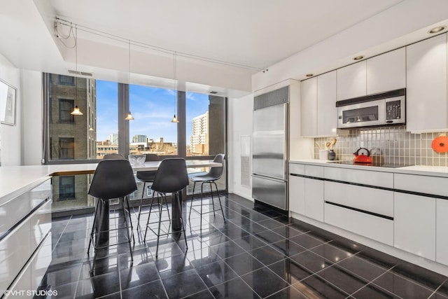 2314 N Lincoln Park W Unit 8-9S, Chicago, IL 60614 - kitchen with a city view, tasteful backsplash, stainless steel appliances, and white cabinets