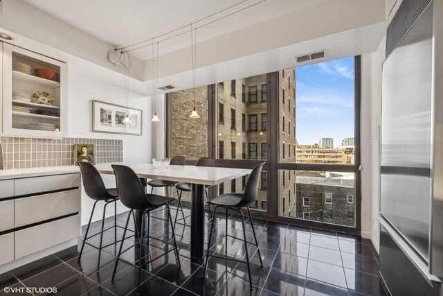 2314 N Lincoln Park W Unit 8-9S, Chicago, IL 60614 - dining space with visible vents and a city view