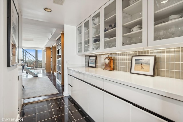 2314 N Lincoln Park W Unit 8-9S, Chicago, IL 60614 - hallway with expansive windows, visible vents, and dark tile patterned flooring