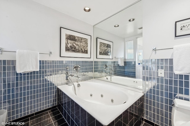 2314 N Lincoln Park W Unit 8-9S, Chicago, IL 60614 - bathroom featuring a whirlpool tub, tile walls, wainscoting, and tile patterned flooring
