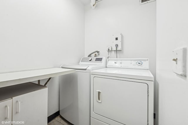 2314 N Lincoln Park W Unit 8-9S, Chicago, IL 60614 - laundry area with cabinet space and washer and clothes dryer