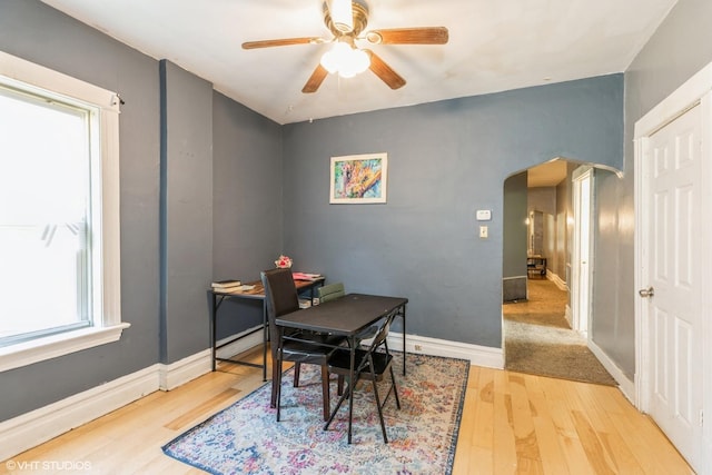 7422 S Kimbark Ave, Chicago, IL 60619 - dining space featuring arched walkways, wood finished floors, a ceiling fan, an office area, and baseboards