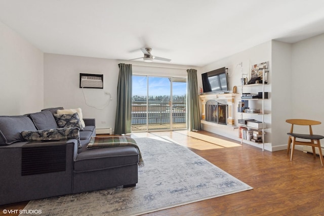 4250 Saratoga Ave Unit 301, Downers Grove, IL 60515 - living room featuring a wall unit AC, a ceiling fan, wood finished floors, baseboards, and a baseboard heating unit