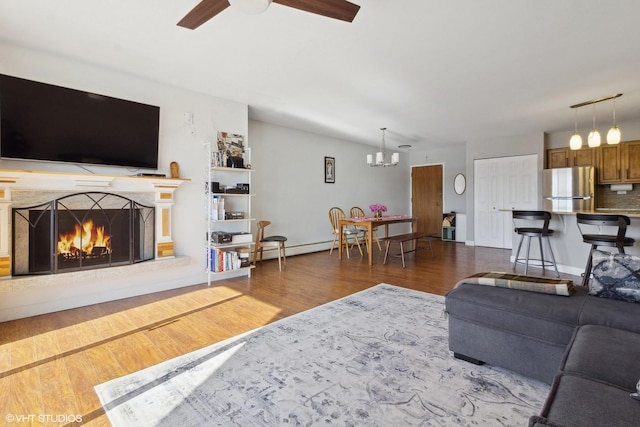 4250 Saratoga Ave Unit 301, Downers Grove, IL 60515 - living area with wood finished floors, ceiling fan with notable chandelier, and a fireplace