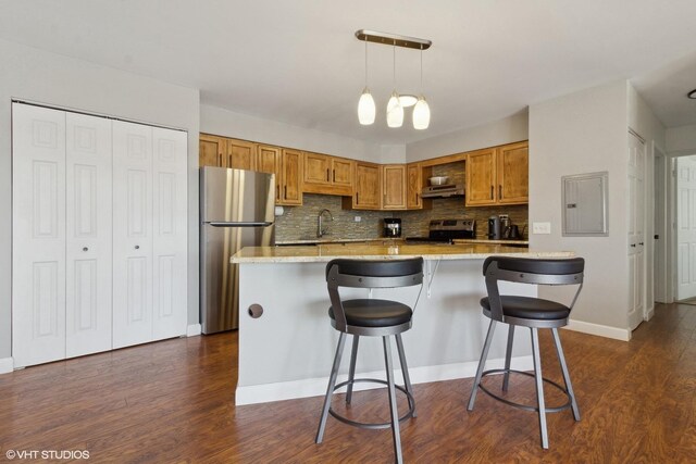 4250 Saratoga Ave Unit 301, Downers Grove, IL 60515 - kitchen featuring decorative backsplash, electric panel, dark wood-style flooring, appliances with stainless steel finishes, and brown cabinets