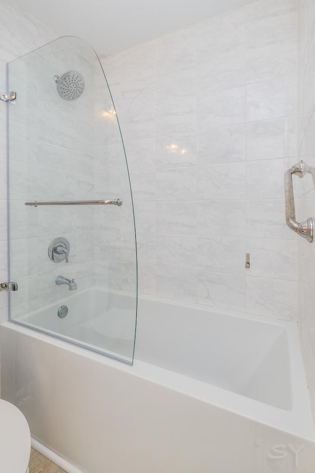 full bathroom featuring washtub / shower combination and toilet