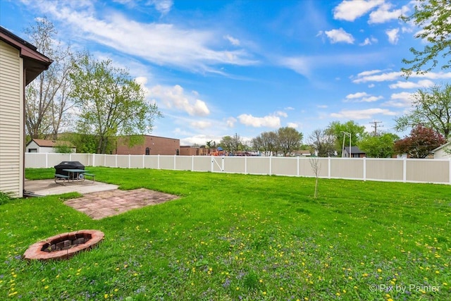 8015 S Carrolton Ct, Hanover Park, IL 60133 - view of yard featuring a fenced backyard, an outdoor fire pit, and a patio