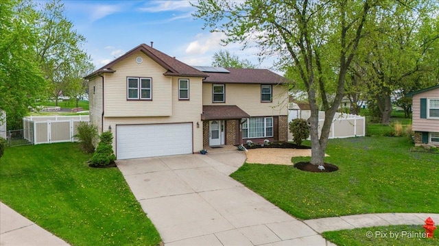 8015 S Carrolton Ct, Hanover Park, IL 60133 - traditional home featuring fence, driveway, a garage, solar panels, and a front lawn
