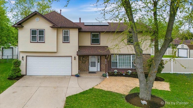 8015 S Carrolton Ct, Hanover Park, IL 60133 - view of front of property featuring a garage, fence, a shingled roof, solar panels, and driveway