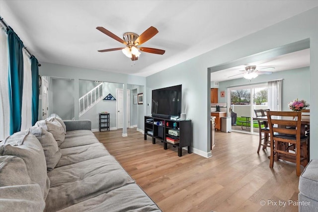 8015 S Carrolton Ct, Hanover Park, IL 60133 - living area with stairway, light wood-style flooring, baseboards, and ceiling fan