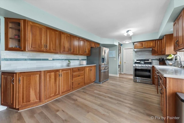 8015 S Carrolton Ct, Hanover Park, IL 60133 - kitchen featuring a sink, stainless steel appliances, tasteful backsplash, and brown cabinets