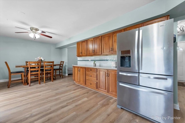 8015 S Carrolton Ct, Hanover Park, IL 60133 - kitchen featuring brown cabinets, light wood-type flooring, decorative backsplash, a ceiling fan, and stainless steel fridge with ice dispenser