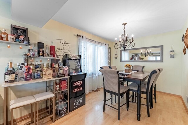 dining space featuring wood finished floors and a chandelier