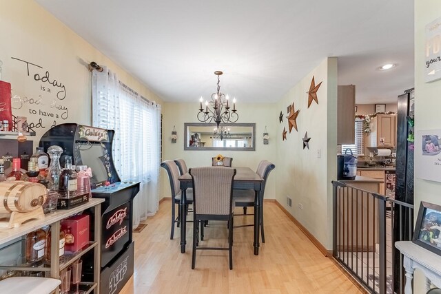 dining area featuring an inviting chandelier and light wood-style floors