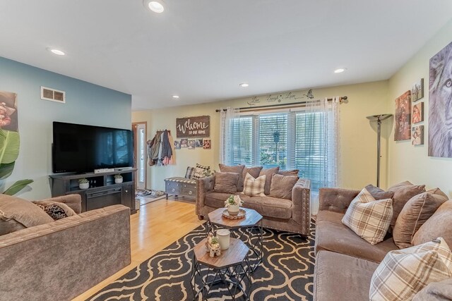 living room featuring recessed lighting, wood finished floors, and visible vents