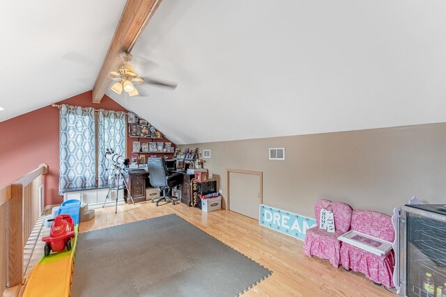 home office with a ceiling fan, vaulted ceiling with beams, wood finished floors, wine cooler, and visible vents