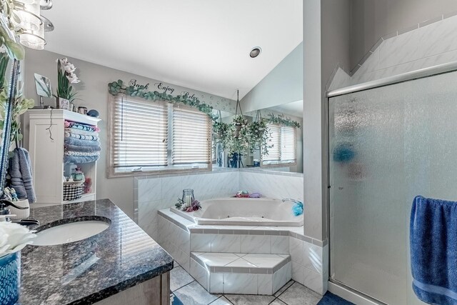 full bath with a bath, tile patterned floors, lofted ceiling, and a stall shower