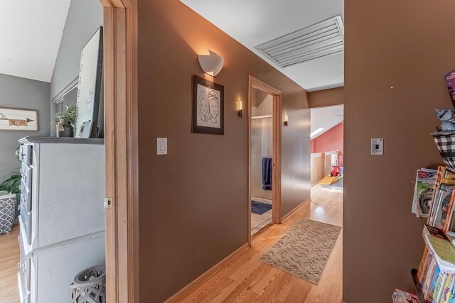 corridor with visible vents and light wood-style floors