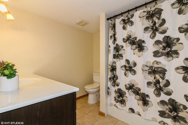 bathroom with toilet, visible vents, tile patterned flooring, and vanity