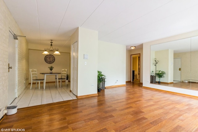 interior space with light wood-type flooring and baseboard heating