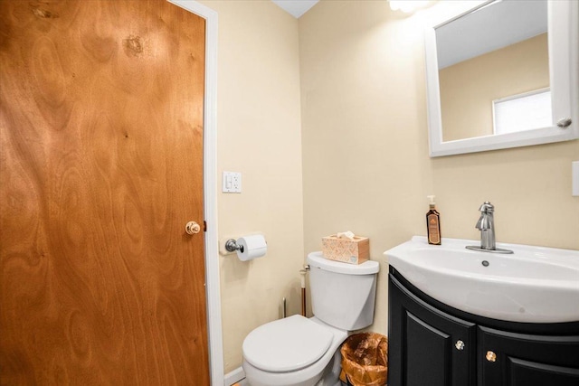 half bath with vanity and toilet
