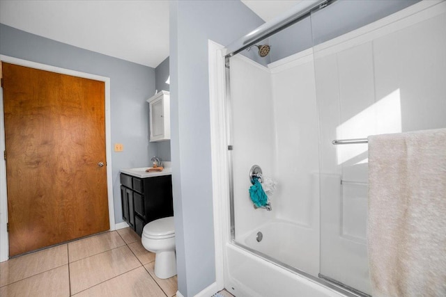 bathroom featuring tile patterned floors, baseboards, bath / shower combo with glass door, vanity, and toilet