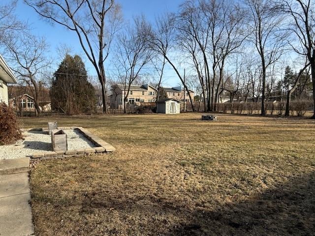 view of yard featuring a storage unit and an outbuilding