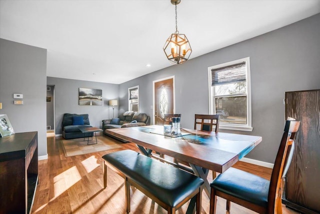 dining area with baseboards, recessed lighting, and light wood-style flooring