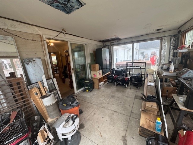 interior space featuring visible vents, plenty of natural light, and unfinished concrete floors