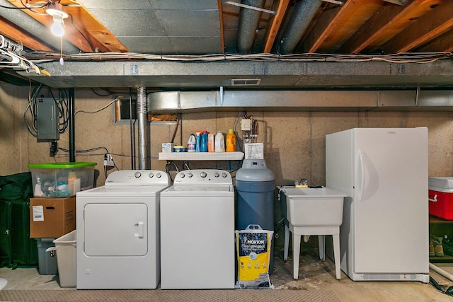2206 Highland Dr, Sycamore, IL 60178 - unfinished below grade area featuring freestanding refrigerator, washer and dryer, and electric panel