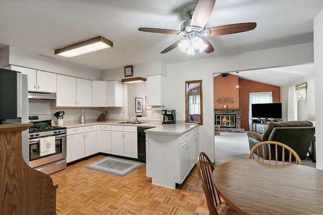 2206 Highland Dr, Sycamore, IL 60178 - kitchen with stainless steel range with gas cooktop, a sink, a brick fireplace, light countertops, and white cabinets
