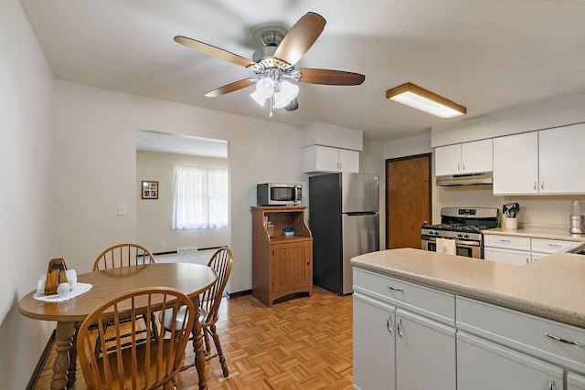2206 Highland Dr, Sycamore, IL 60178 - kitchen featuring stainless steel appliances, under cabinet range hood, a ceiling fan, white cabinets, and light countertops