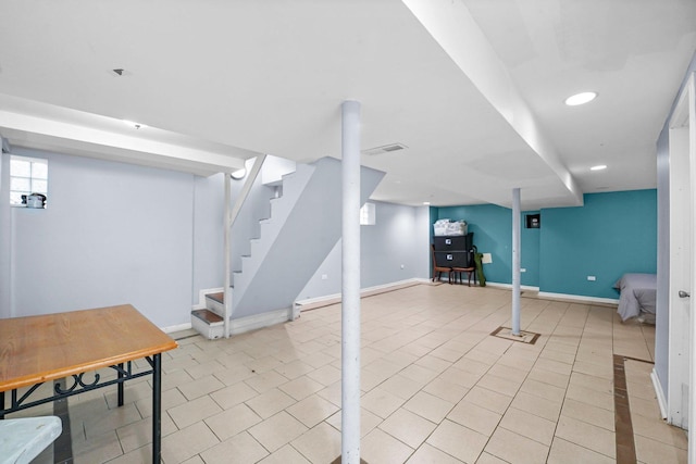 below grade area with light tile patterned floors, baseboards, stairway, and recessed lighting