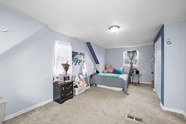 bedroom with baseboards, visible vents, and carpet