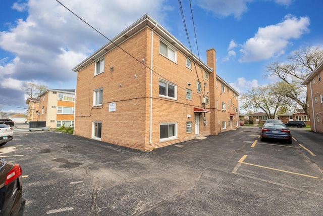 view of property featuring uncovered parking