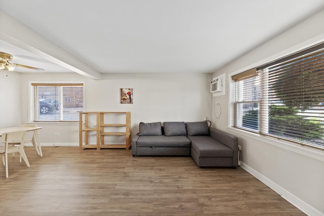 living room with a healthy amount of sunlight, a ceiling fan, and light wood-type flooring