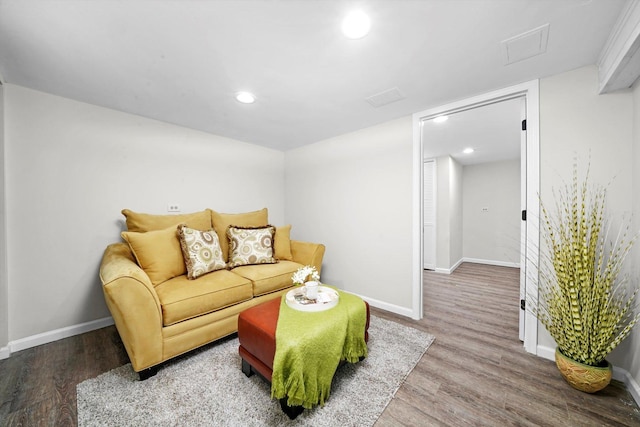 living area with recessed lighting, baseboards, and wood finished floors
