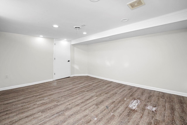 finished basement featuring baseboards, recessed lighting, wood finished floors, and visible vents