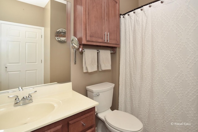 full bathroom with vanity, a shower with shower curtain, and toilet