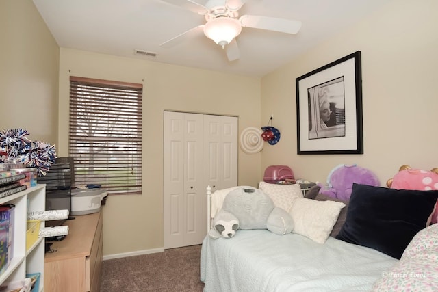 bedroom with carpet floors, visible vents, a closet, baseboards, and a ceiling fan