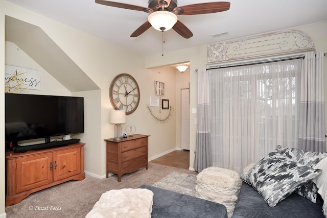 bedroom with light colored carpet, a ceiling fan, and baseboards