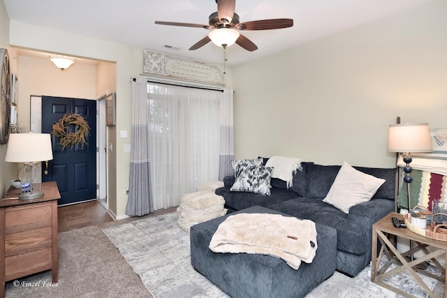 carpeted living room featuring ceiling fan