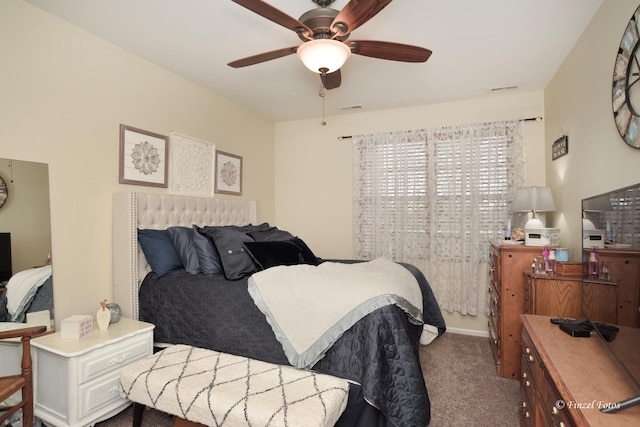 carpeted bedroom with visible vents and a ceiling fan