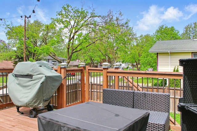 wooden terrace featuring a grill