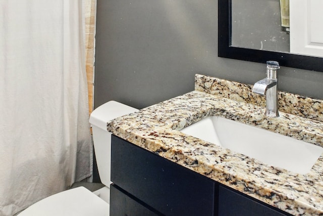 full bath with toilet and vanity