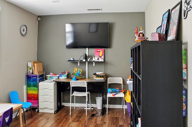 home office featuring visible vents and wood finished floors