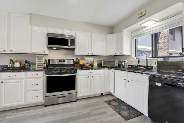 7333 Winthrop Way Unit 10, Downers Grove, IL 60516 - kitchen featuring appliances with stainless steel finishes, a sink, white cabinetry, and light wood-type flooring
