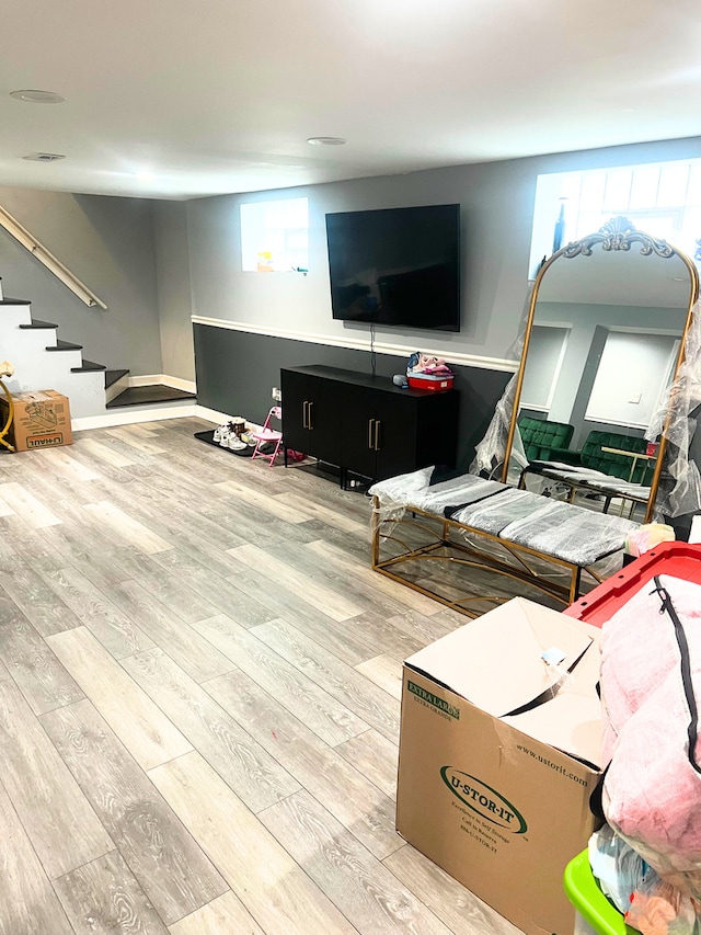 living room with stairs and wood finished floors